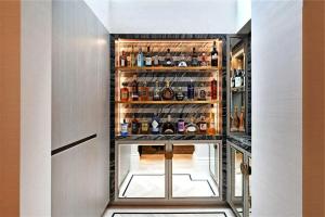 a bar in a hallway with alcohol bottles at Kos blue & green in Kos