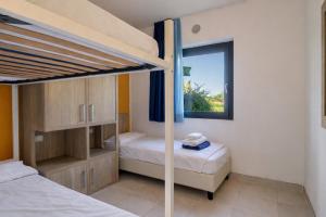 a bedroom with two bunk beds and a window at Belvedere Village in Castelnuovo del Garda +36 photos