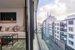 a living room with a couch and a view of a city at Résidence Happy Living in Casablanca