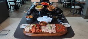 a buffet of food on a table in a restaurant at Four Points by Sheraton Budapest Danube in Budapest +48 photos