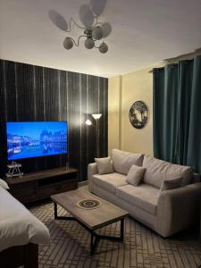 a living room with a couch and a flat screen tv at Sitati in Ruaka