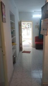 a hallway with a door leading to a living room at Ganga Homestays in Tiruvannāmalai +1 photo