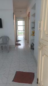 a hallway with a door and a tile floor at Ganga Homestays in Tiruvannāmalai