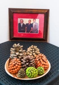 a plate with pine cones and a picture of three men at Quinta Toca do leão in Ribeira Grande