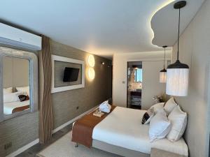 a hotel room with a bed and a mirror at Hôtel Eve Cap d'agde Village Naturiste in Cap d'Agde