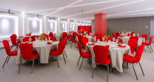 a conference room with tables and chairs and red chairs at Ada Suites Nisantasi in Istanbul