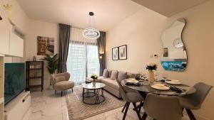 a living room with a couch and a table at Cozy Poolside 1BR - Serene Luxe Chic Retreat in Abu Dhabi