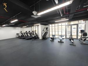 a gym with several treadmills and exercise bikes at Cozy Poolside 1BR - Serene Luxe Chic Retreat in Abu Dhabi
