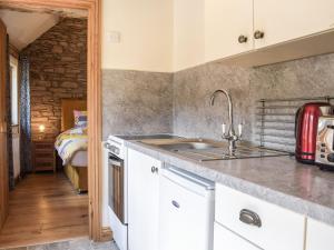 a kitchen with a sink and a counter top at Badgers Den - Uk32084 in Dorstone