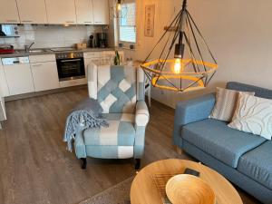 a living room with a couch and a chair and a table at Apartment Alleestraße in Büsum