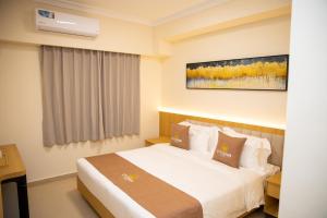 a hotel room with a bed in a room at City Crown Hotel in Dar es Salaam +24 photos