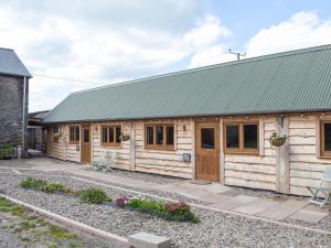 a wooden cabin with a green roof at Gooses Roost - Uk32096 in Dorstone