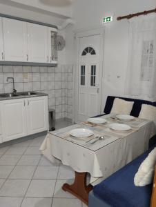 a kitchen with a table with plates on it at La Campagne Ioannina Kranoula in Ioannina +37 photos