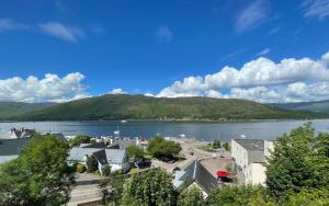 a view of a town and a lake with mountains at Historic Highland Townhouse in Fort William