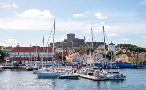 a group of boats docked in a marina with buildings at Villa Marstrand in Marstrand