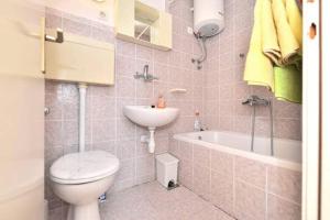 a bathroom with a toilet and a sink and a tub at Studio apartment in town center in Stari Grad