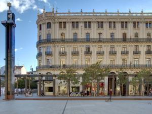 a large building in front of a street at Hotel Pilar Plaza in Zaragoza