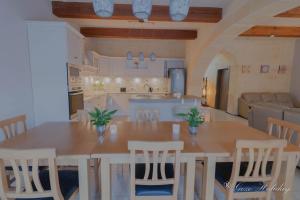 a kitchen and living room with a table and chairs at Hollies in Qala