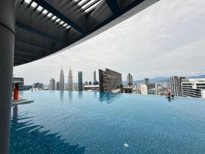 a swimming pool on the roof of a building with a city at IKON SUITE's E A T O N KLCC in Kuala Lumpur