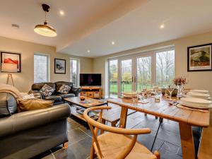 a living room with a table and a couch at 3 Bed in Keswick oc-93589 in Threlkeld