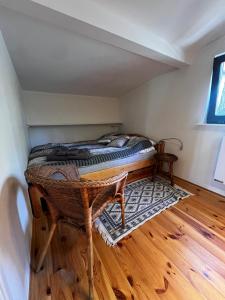 a bedroom with a bed and a wooden floor at Domek letniskowy "Wiewiórka" - Oaza Spokoju in Ocypel
