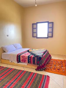 a bedroom with two beds and a window at Sahara desert Maison in Merzouga