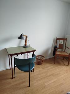 a desk with a chair and a table with a lamp at Aoja in Maasmechelen +15 photos