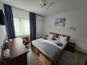 a bedroom with a bed with blue pillows on it at Pensiunea Transilvania in Sibiu