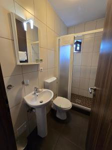 a bathroom with a sink and a toilet at Pensiunea Transilvania in Sibiu +54 photos
