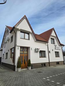 a white house with a brown roof at Pensiunea Transilvania in Sibiu