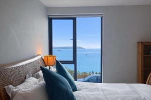 a bedroom with a bed with a view of the ocean at 14 Dun Farraige in Cobh