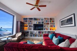 a living room with a red couch and a large window at 14 Dun Farraige in Cobh