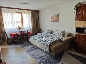 a bedroom with a bed and a dining room at Bansko Pirin Golf & Country Club Blue Mountains View in Razlog