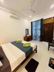 a bedroom with a large bed and a living room at Luxury Living Villas in Matara