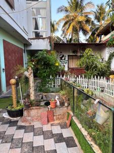 a garden in front of a house with plants at Gokarna City Guest House in Gokarna