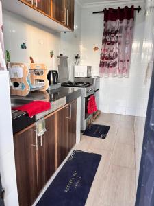 a kitchen with wooden cabinets and a stove top oven at Serenity Homes in Ruiru