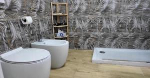 a bathroom with a toilet and a sink and a tub at Love Suite in Catania