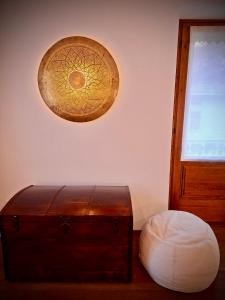 a light hanging over a room with a wooden chest at La Casa di Lumi in Lanzada +4 photos