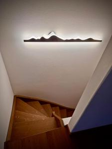 a light on a ceiling with a wooden floor at La Casa di Lumi in Lanzada
