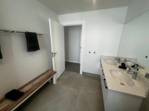 a white bathroom with a sink and a mirror at Seabreeze Golf Retreat in St Francis Bay +36 photos