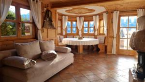 a living room with a couch and a table at Ferienhaus Kleinlercher in Iselsberg