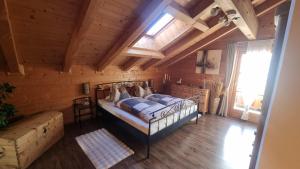 a bedroom with a bed and a wooden ceiling at Ferienhaus Kleinlercher in Iselsberg