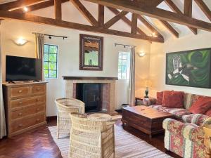 a living room with a couch and a fireplace at Hornbill Cottage in Nairobi