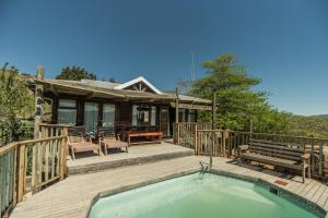 a house with a hot tub on a deck at Intaba Lodge in Kirkwood +23 photos