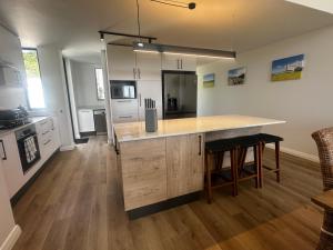 a kitchen with a island in the middle of a room at Seabreeze Golf Retreat in St Francis Bay