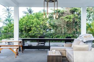 a living room with a couch and a table at SouthStone Paradise in Balapitiya