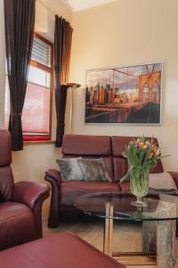 a living room with a couch and a table at Seabreeze Suite in Füssen +3 photos