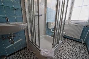 a bathroom with a shower and a sink at Appartement-8 in Süddorf +10 photos