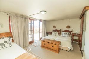a bedroom with two beds and a window at Intaba Lodge in Kirkwood