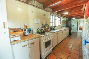 a large kitchen with a stove and a sink at Intaba Lodge in Kirkwood